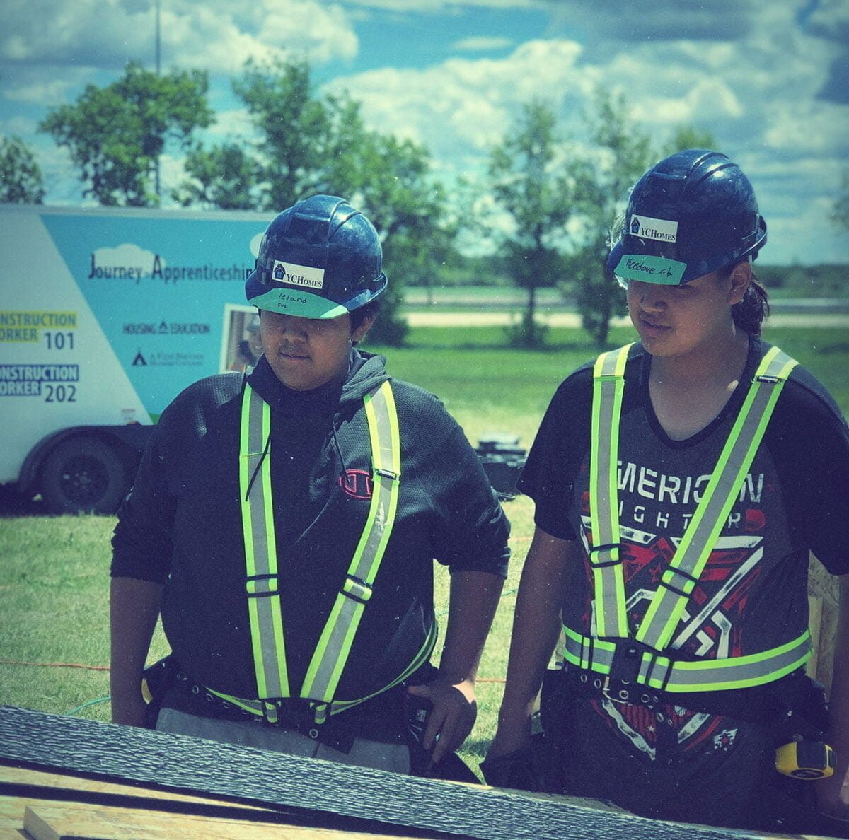 Image of two indigenous apprentices on site