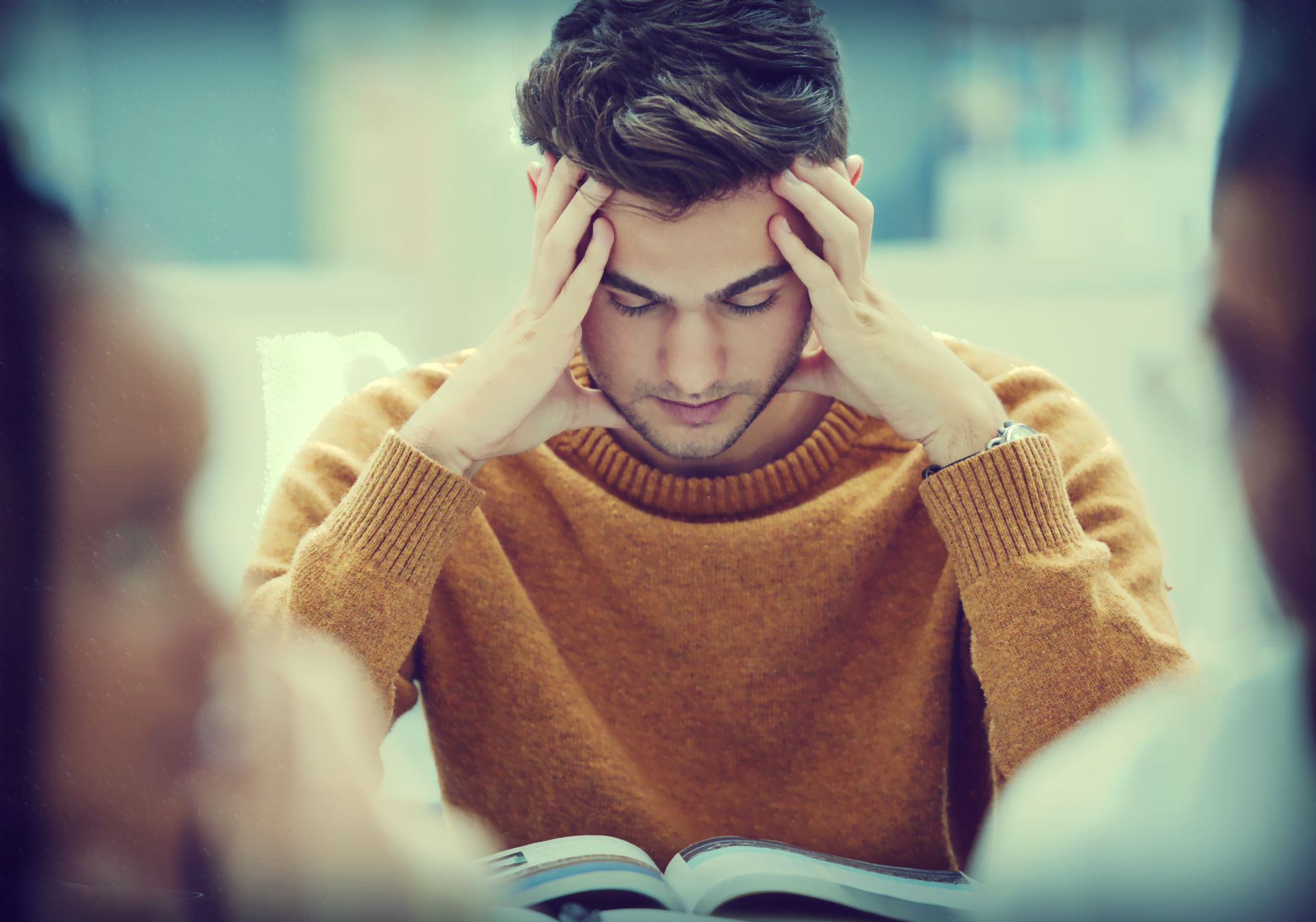 A student looking at books and appears stressed